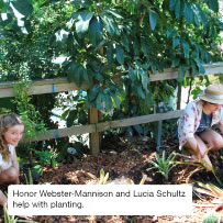 Honor Webster-Mannison and Lucia Schultz help with planting.